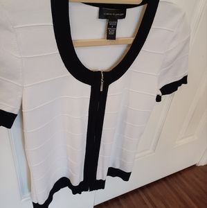 cable & gauge sweater. White with black trim around collar, cuffs and front.